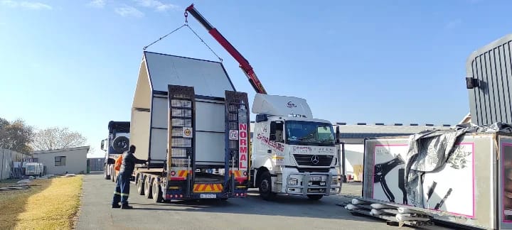 Crane truck lifting a structure on site